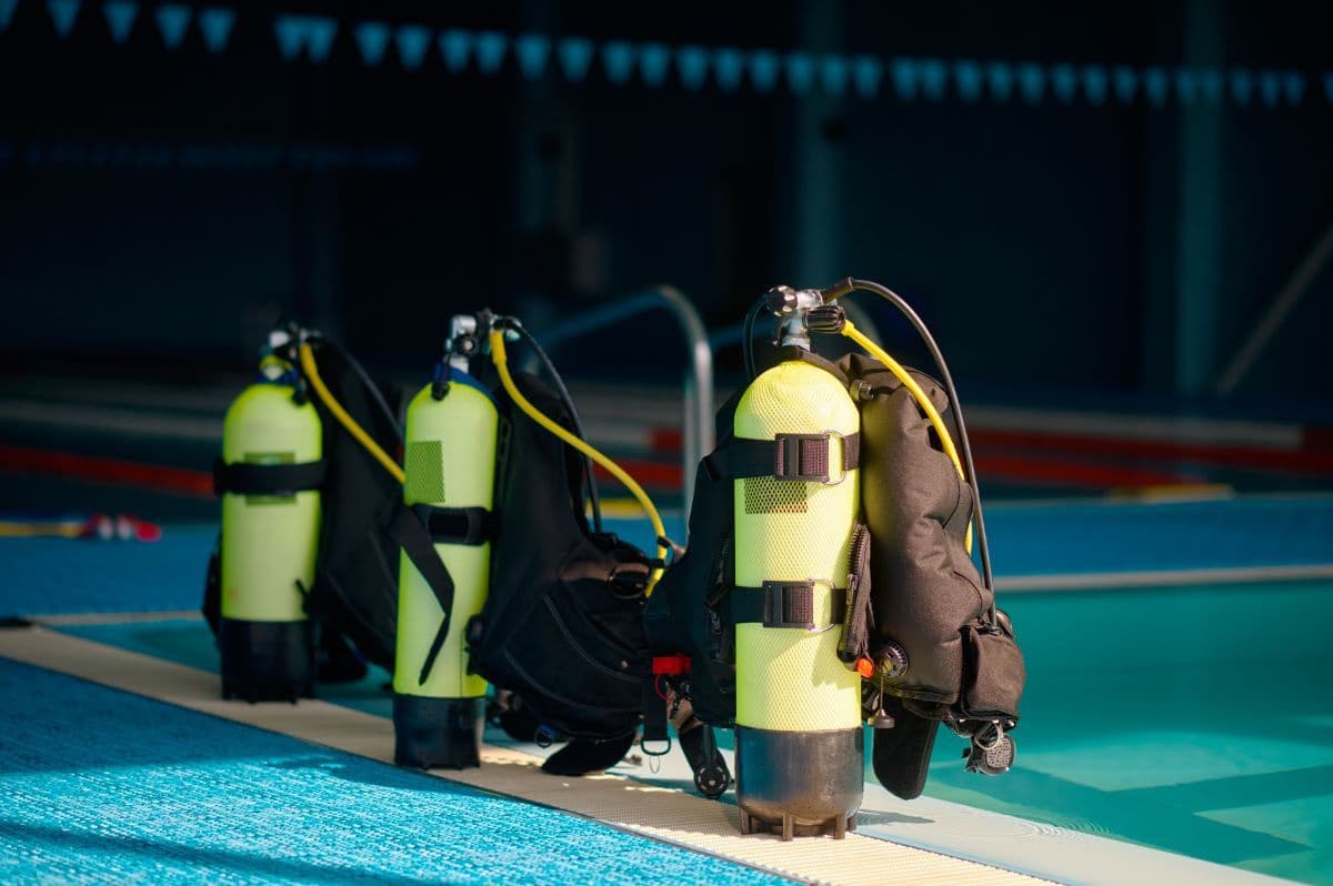 three-oxygen-tanks-at-poolside-diving-equipment-2021-09-18-05-51-48-utc.jpg